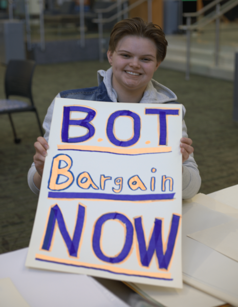 A student helps to decorate signs for ECCFA. Jan 29, 2026.