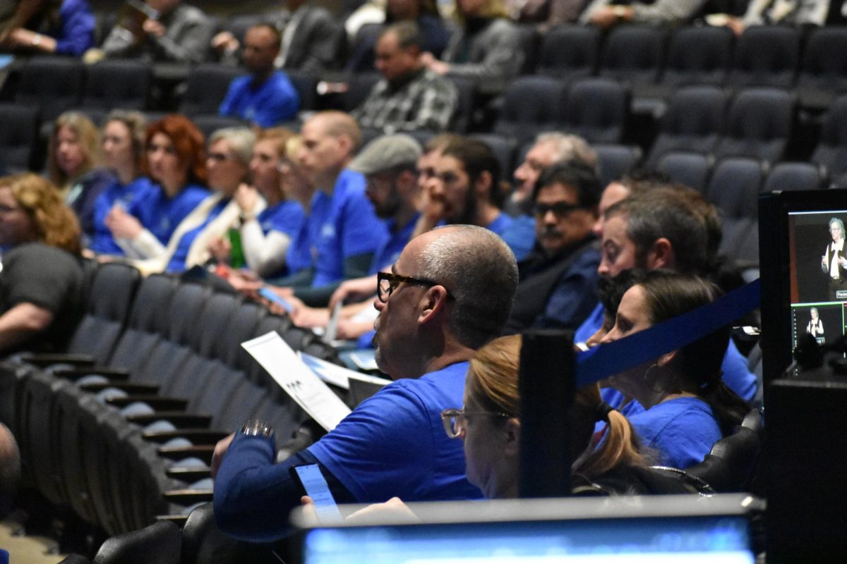 Attendees in the Blizzard Theatre ask questions about the speaker's presentation.
