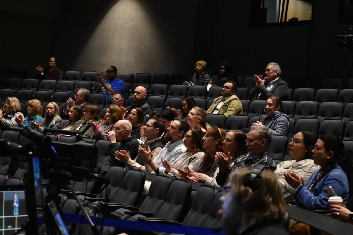 Small groups of people sit in to listen to the presentation in the Blizzard Theatre.