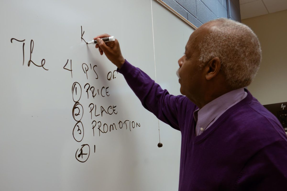 Clark Hallpike writes lesson notes on classroom whiteboard during lecture on January 28, 2026.