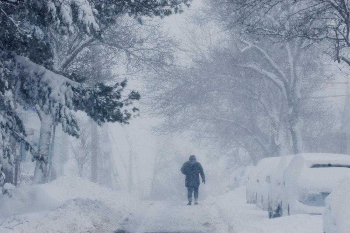 A person walks through a winter blizzard snow storm in Somerville, Massachusetts, U.S., February 23, 2026.   REUTERS/Brian Snyder