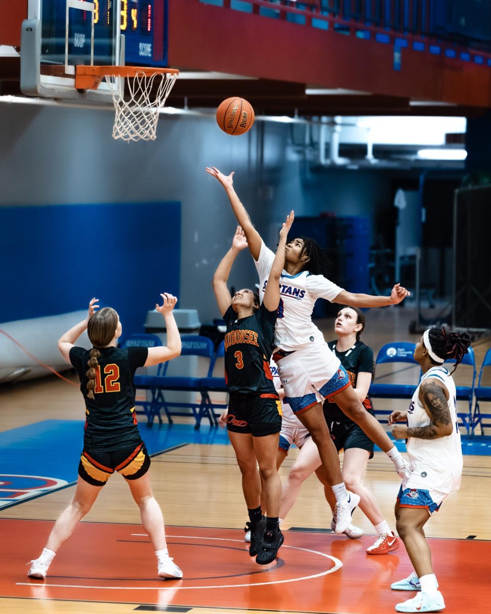 Forward Asha Gray leaps for the defensive rebound over three defenders, on February 12, 2026. The Spartans gathered 23 defensive rebounds against Waubonsee Community College, crashing the glass and getting back on offense.