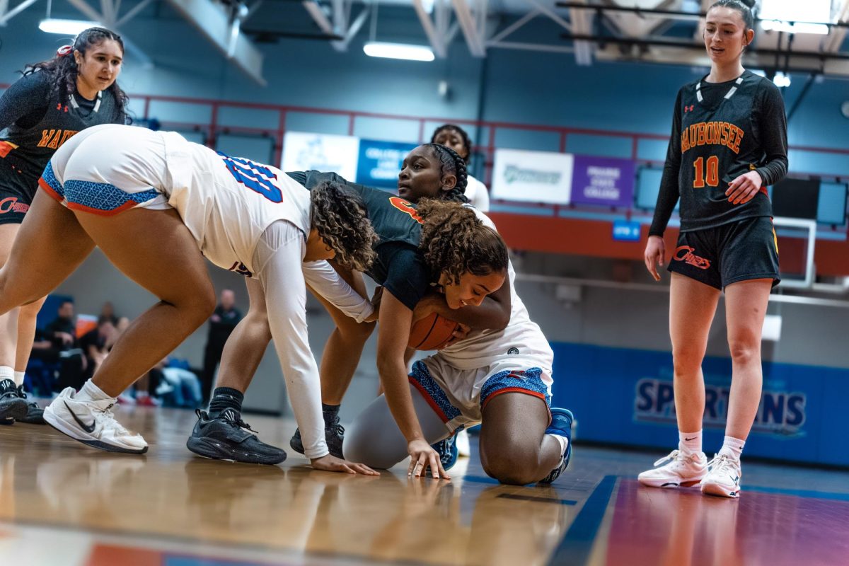 Forward Tori Ruffin and Guard Alisea Doan battle Waubonsee on the loose ball, leading to a jump-ball, on Feb.12, 2026. The turnover would be one of 13 generated against Waubonsee, by the Spartans this game.