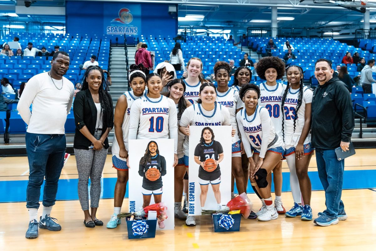The women's basketball team gather around guards Alisea Doan and Abigail Esparza, after a ceremony honoring sophomores, on February 12, 2026. Doan and Esparza have collectively played 102 games in their tenure, with 80 games as starters.