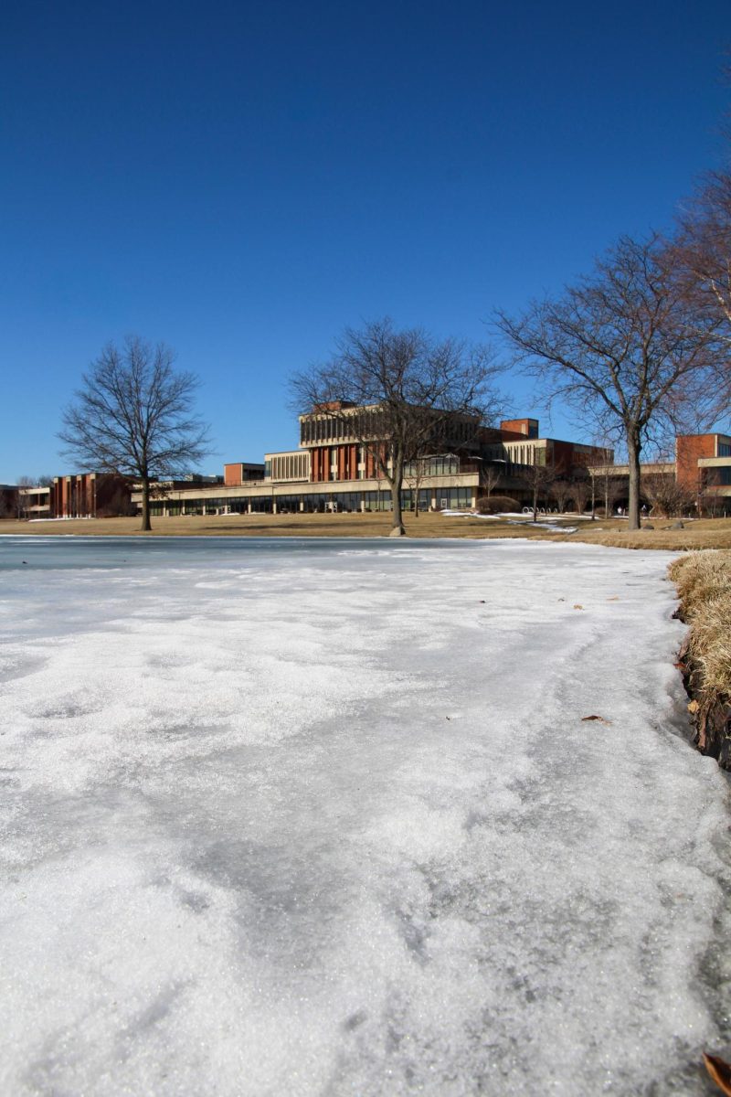 Snow builds on a frozen-over Lake Spartan at Elgin Community College on Feb. 11, 2026. Lake Spartan was frozen for weeks in the winter season as temperatures were consistently below-freezing.