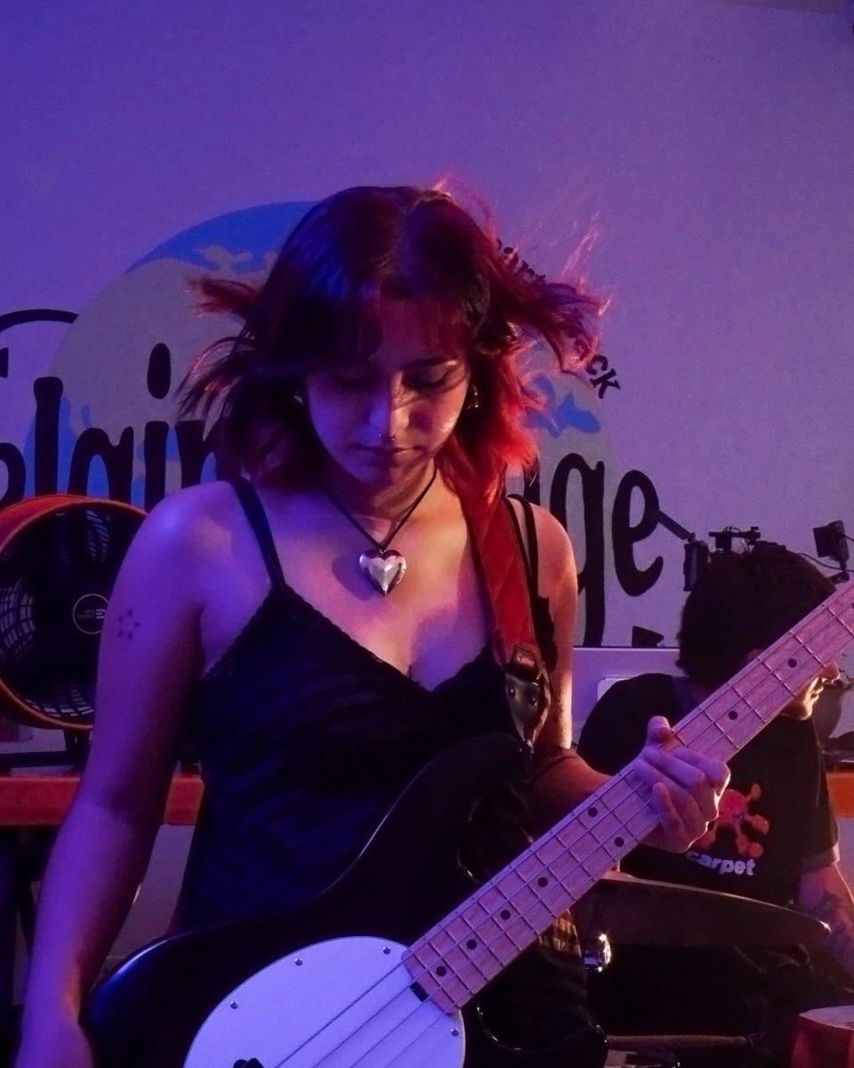 Emily Vela, bassist of Vatos Tristes, during the “Sugar Water” music video shoot at Elgin Vintage, on June 27, 2025. The band began by covering songs during the summer of 2023 and has since created its own sound.