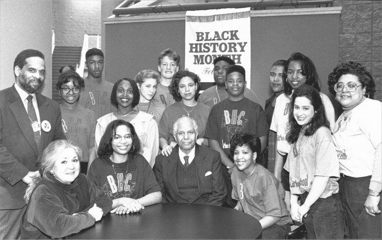 Tuskegee Airman (seated in center) Andrew Lane and C.R. Bradford (standing left) from Larkin High School with Larkin High School students.