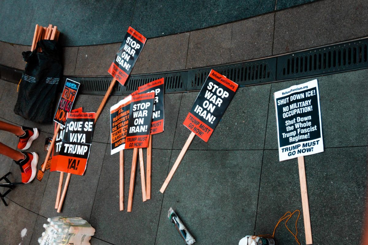 Signs calling out the Trump Administration's war on Iran, and ICE operations, on Mar. 8th, 2026. Protests have been organized around the country, following the Trump Administration's Feb. 28th missile attack on Iran.