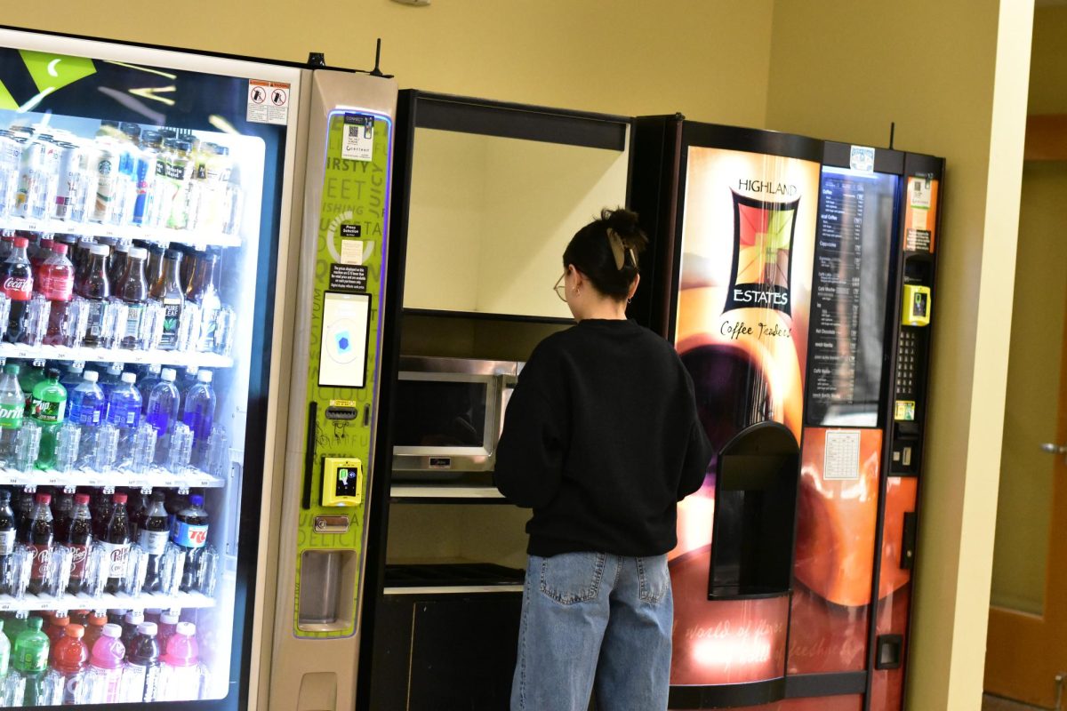 A student uses the community microwave in building B on Mar. 23, 2026. The microwave was used to heat up food, which allowed students to grab a bite before class.