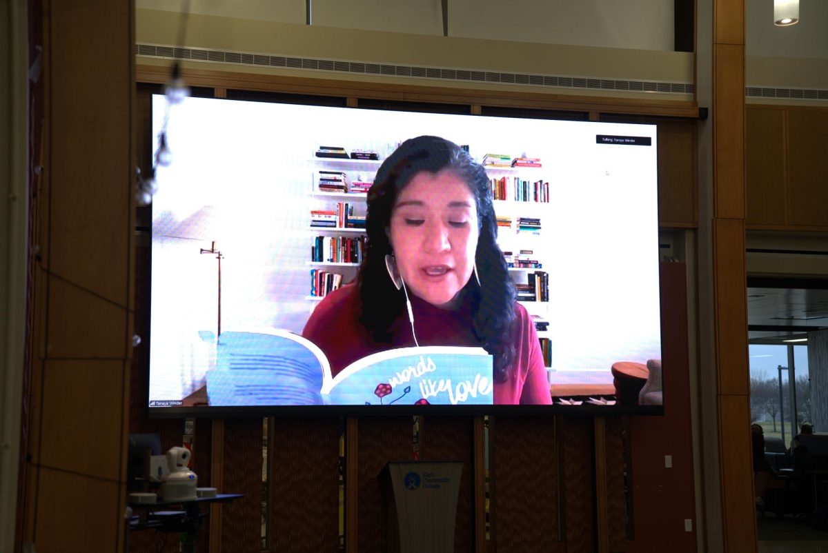 Speaker reads from a book on zoom.