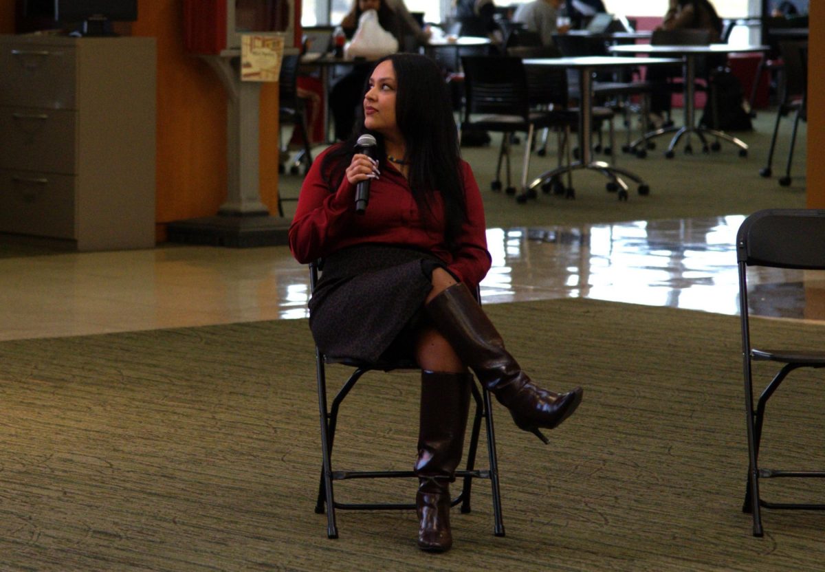 Seated speaker with a microphone.