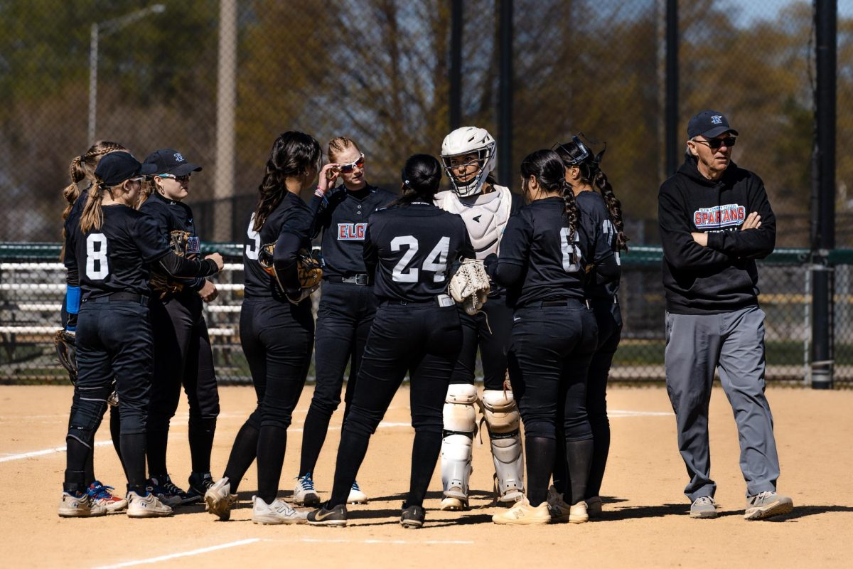 Elgin Community College's softball team, communicate between innings, making necessary adjustments that would lead to a eight run comeback 11-5 win over Prairie State College on Apr. 20, 2026. While the team came out with a comeback win, they end their run of home games at 4-6, with their overall record this season being 8-24.