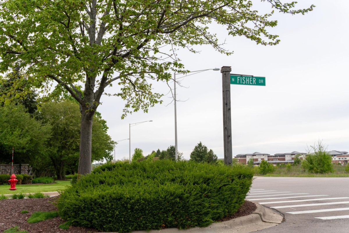 Bricher Rd & Fisher Dr intersection in Geneva, IL. with nearby residential buildings lining the roadway. on May 5, 2026, 