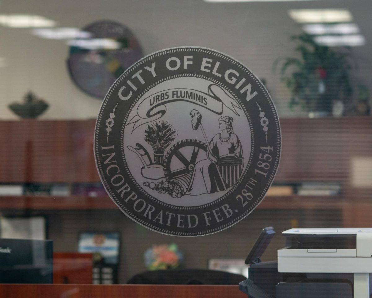 The City of Elgin seal displayed on a glass partition inside the City Court facility in downtown Elgin, reflecting the city’s history and incorporated status on Apr. 27, 2026
